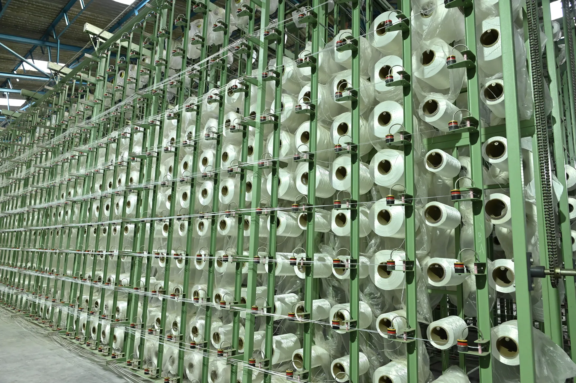 Yarn bobbins arranged on the creel at the Jayatma workplace