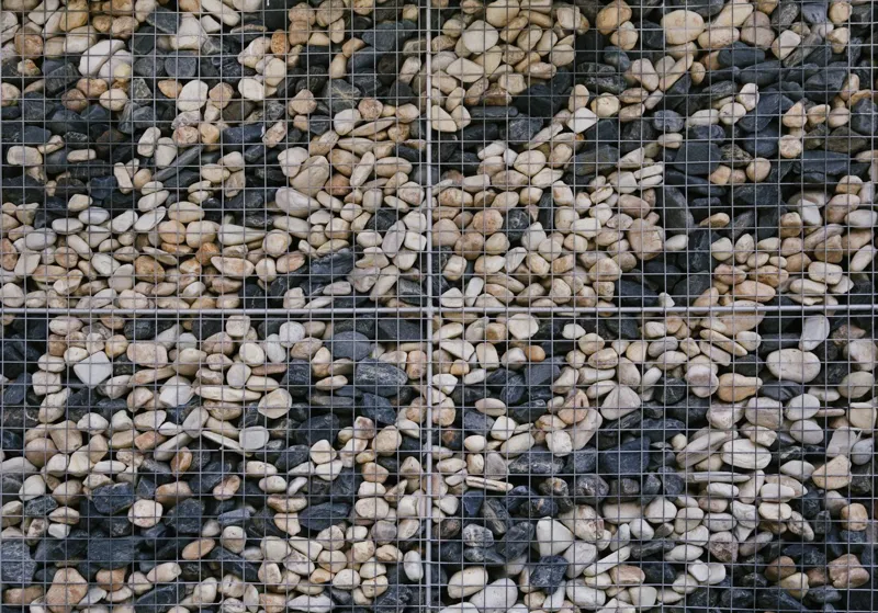 Stone-filled gabion retaining wall